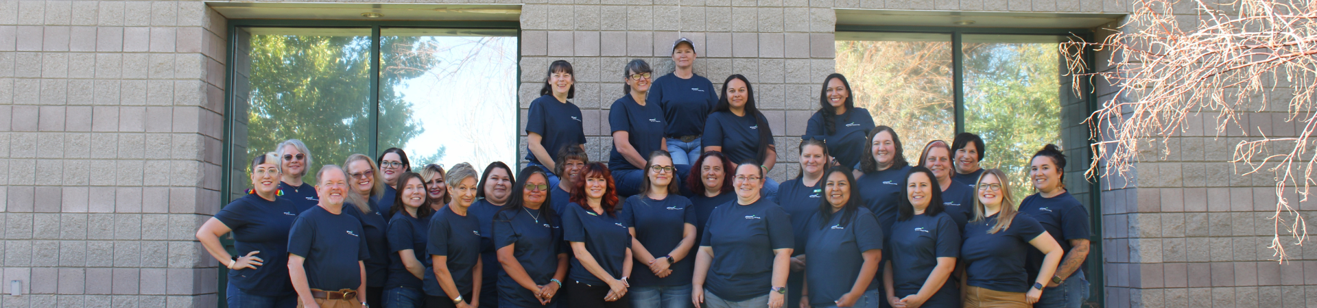 girl scout staff or volunteer wearing adult vest in woods smiling 